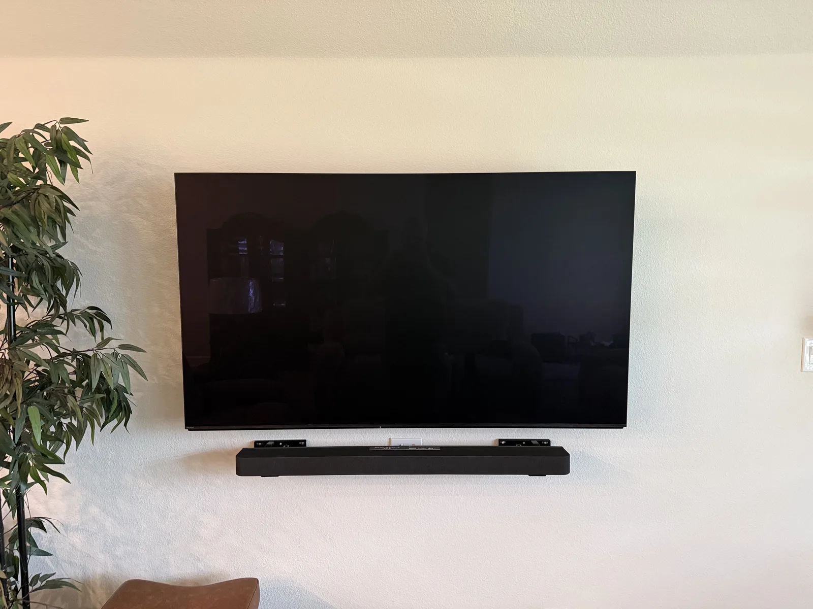 Sony Bravia 8 TV with Bravia 8 soundbar wall-mounted beneath it in Lavon, TX, no visible wires