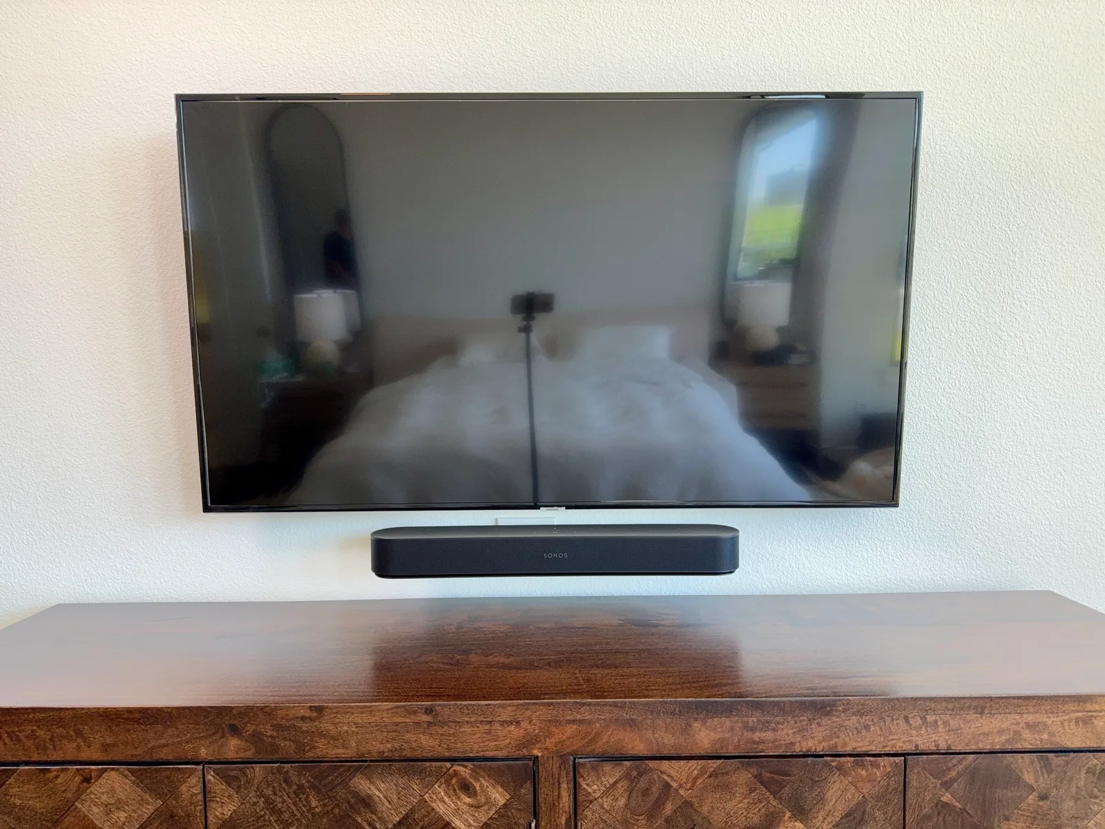 Samsung TV with Sonos soundbar centered beneath it, wall-mounted above a media console in Frisco, TX, no visible wires